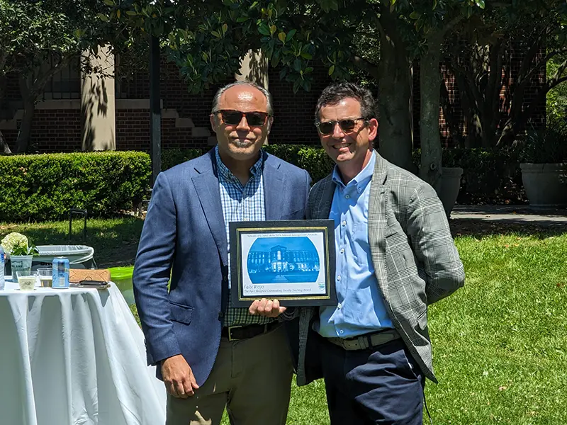 Felix Rioja receiving the April Brayfield Outstanding Faculty Teaching Award from Dean Brian Edwards