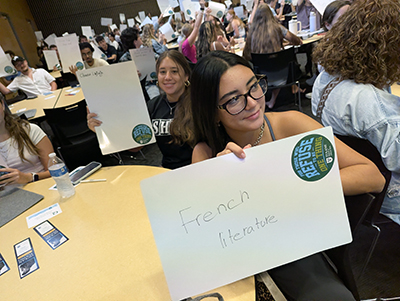 Students hold up dry erase board for an interactive game at the Dean's Welcome Assembly