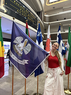represent Louisiana on an international stage at the 11th student at Student posing with state of Lo