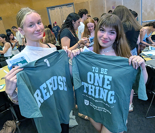 Two students showcase their Bingo winning tshirts