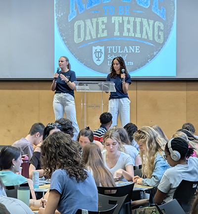 Two Student Advisory Board members speak to students at the Dean's Welcome Assembly.