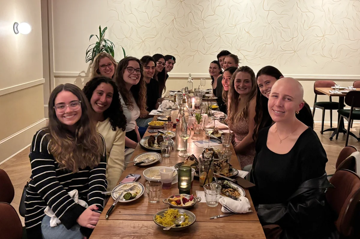 Students gathered around a dinner table for a Wiener Scholar dialogue event