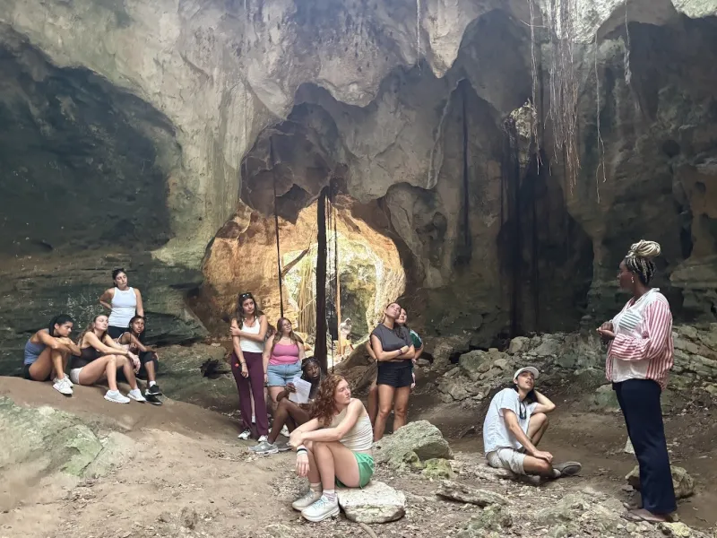 Beyond Paradise students in a cave with Rachel Buissereth, director of partnerships at The Island Sc
