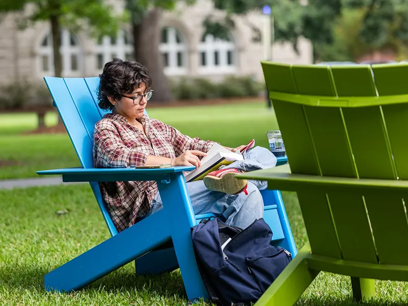 Tulane University student reading on campus
